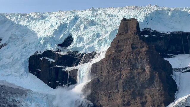 A small avalanche formed as a result of the melting of a glacier. Sol glacier. Scoresbysund, Greenland.
