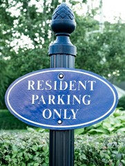 Resident Parking Only parking lot sign. Nice blue sign on green post with decorative pine cone...
