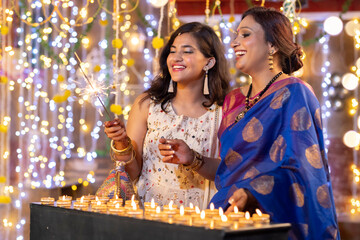 Mother and daughter celebrating traditional diwali festival