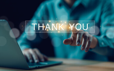 businessman using a laptop and touching the message thank you on a display screen. concept of thank...