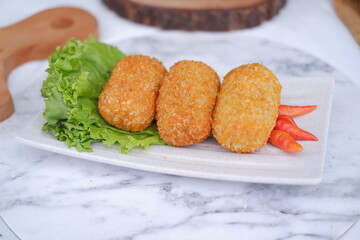 Fried croquettes on a white plate. Selective focus.