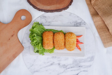 Fried croquettes on a white plate. Selective focus.