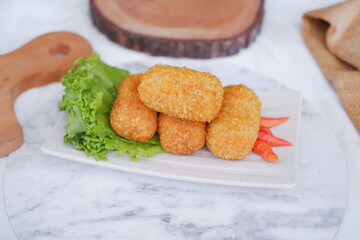 Fried croquettes on a white plate. Selective focus.