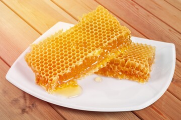 Tasty sweet Honeycomb with syrup on plate