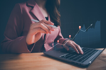 Businesswoman using computer laptop to analyze financial data chart  investing in stock markets....