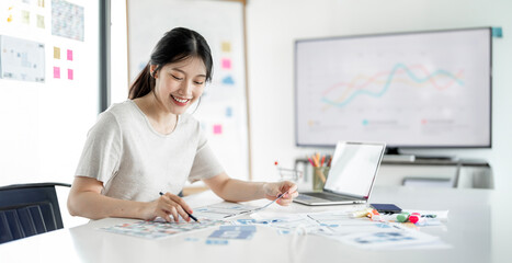 Young asian freelancer or designer working at her home office.