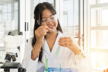 Asian child girl scientists learning science and doing analysis with microscope in the laboratory. Science and education, research and discovery concept