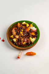 pieces of fresh fruit mixed with sweet peanut sauce and fresh pickled fruit in a glass cup