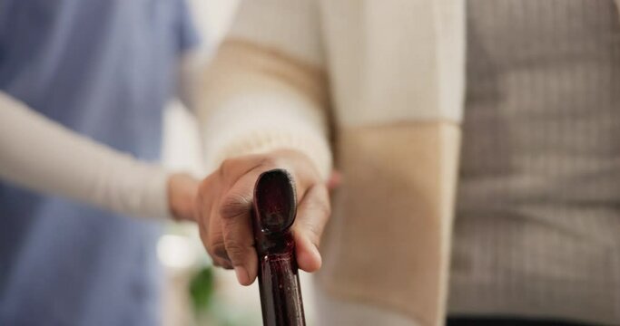 Nurse, hands and support person with walking stick in nursing home for balance, medical help and rehabilitation. Caregiver, patient with disability and closeup for homecare, parkinson or mobility aid