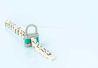 Padlock stopping domino effect falling. Safety concept..