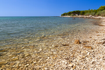Fototapeta na wymiar Beach on the stone coast of Beach Kastanija, Novigrad Istria, Croatia, Europe