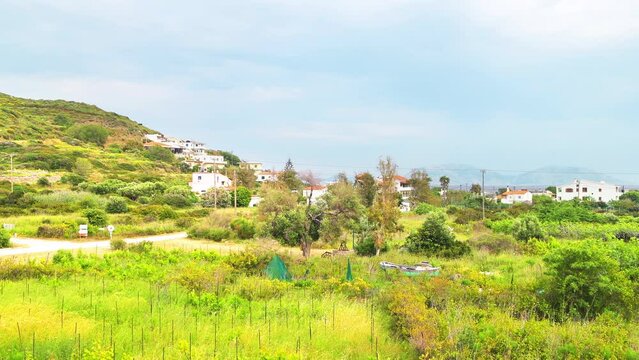 Faros Ikaria island, Greece small fishing village cityscape, houses homes by gardens at Aegean Ikarian sea of Mediterranean in longevity blue zone