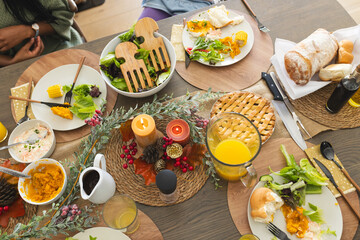 Thanksgiving dinner celebrating by african american parents, children and grandparents