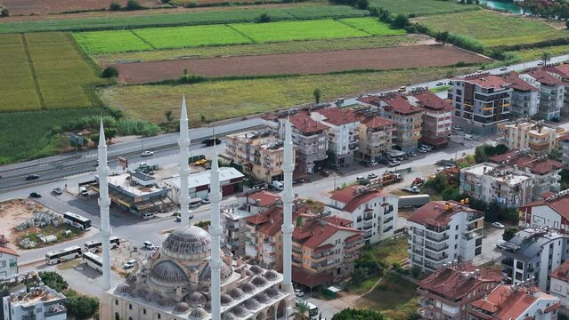 Aerial view flyover Manavgat mosque, Turkey, Approaching farmland fields in the Antalya region