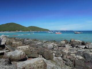 Rocky beach, speedboat and sea