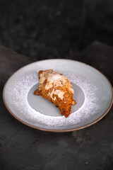 almond croissant with powdered sugar