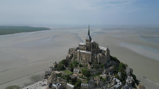 Mont St Michael Tidal island Normandy France tide out pull back drone aerial reverse reveal
