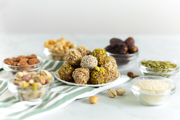 Handmade energy balls with nuts, dried fruits. healthy sweet snack, candy free sugar. raw dessert made from dates, almond, cashew. Vegetarian organic food with vitamins