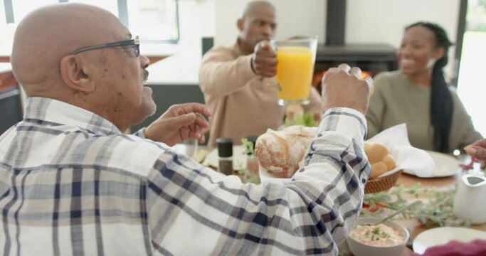African american parents, children and grandparents celebrating at thanksgiving dinner, slow motion