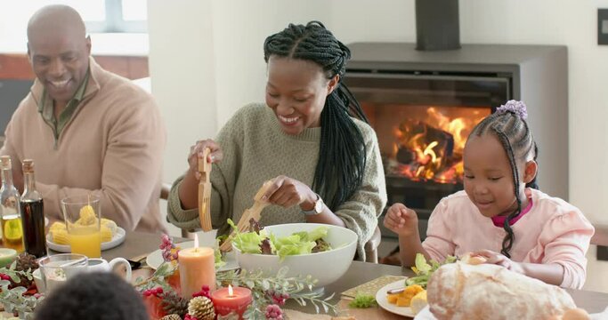 African american parents, children and grandparents celebrating at thanksgiving dinner, slow motion