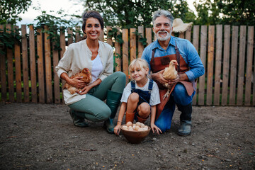 Family portrait with chicken in the garden