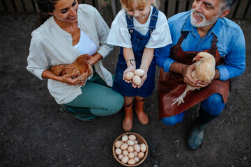 Family showing collected chicken eggs