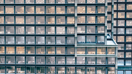 facade of an apartment building. facade of a building in 3d. exterior view of apartments with lights on. background of a residential tower in 3d