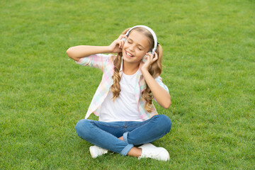 teen girl listen to music. carefree and happy childhood. lifestyle of teen girl. music of her childhood. listening to music in headphones outdoor. teen girl listen a song in wireless headphones