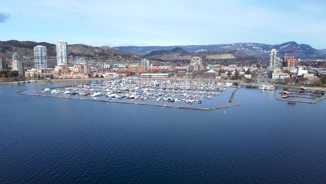Aerial Drone Shot of the Beautiful of City Kelowna British Columbia. Downtown Kelowna Waterfront Catch Club and Boardwalk on a beautiful day.