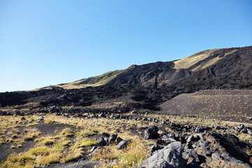 Mount Etna, Sicily, Italy. Slopes of volcano are covered with volcanic ash and frozen lava. Summer...