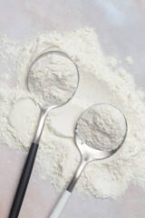 White powder in the spoon. Collagen protein powder or wheat flour. Concept of nutritional supplement, dieting, detox, preventive healthcare and healthy lifestyle. 