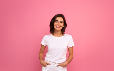 Portrait of smiling woman pink background with white t-shirt.