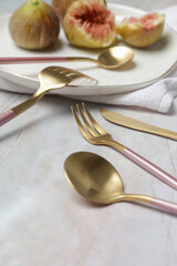 Creative shot of golden cutlery on marble table, Design concept. Modern kitchen. Scandinavian style tableware.