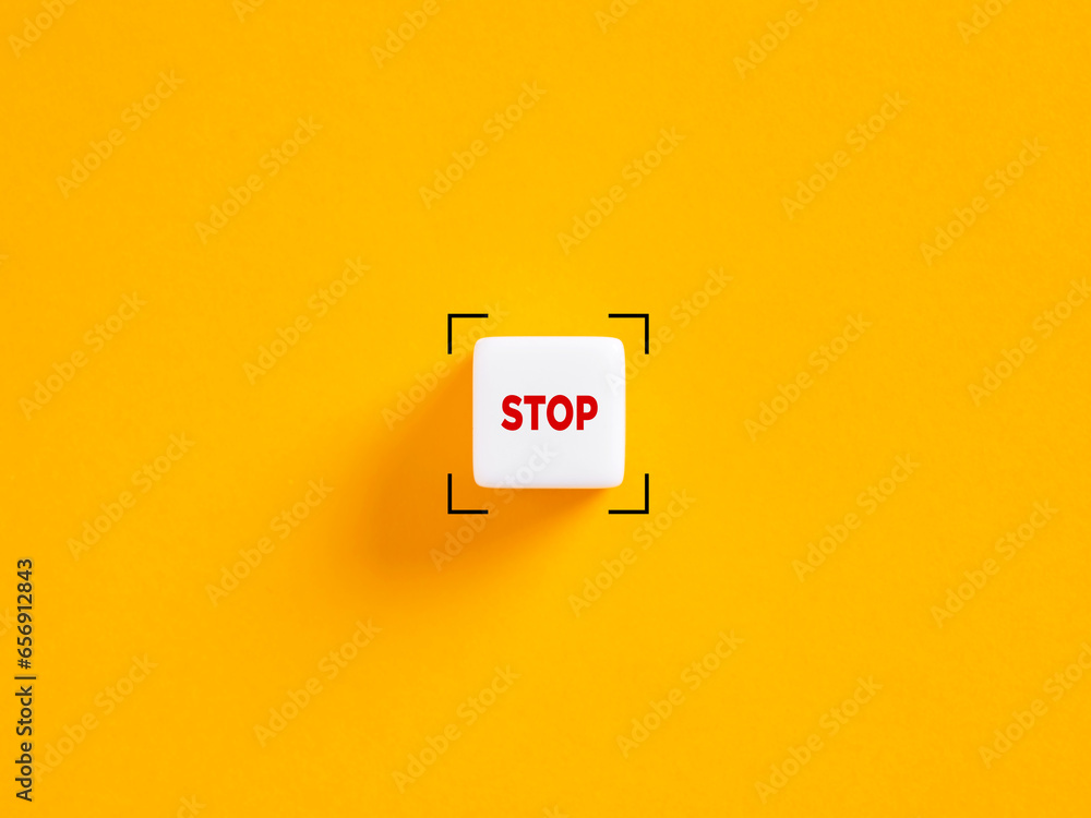 Poster stop push button. the word stop on white cube on yellow background.