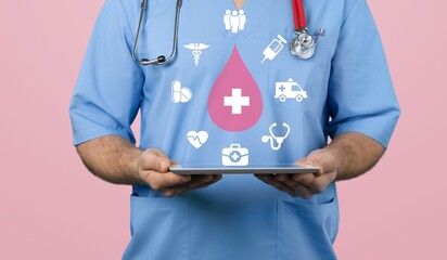 hands holding pink blood drop, donor day concept