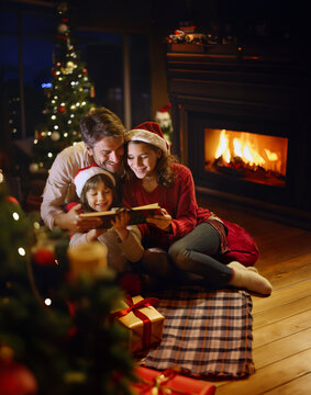 A joyful family gathering around a warm fireplace during Christmas. Generative ai