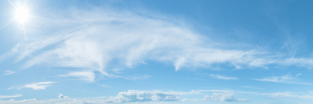 Blue panoramic sky with clouds and sunray. High resolution photo. Summer blue sky cloud gradient light white background. Beauty clear cloudy in sunshine calm bright winter air background.