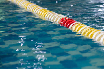 yellow, white and red buoys in the indoor pool. - obrazy, fototapety, plakaty