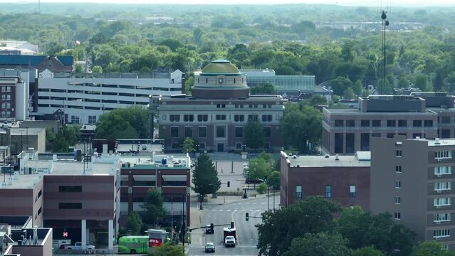 Long shot of Stearns County Courthouse in downtown St Cloud, Minnesota. Aerial establishing shot of small town in MN.