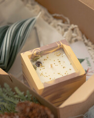 Christmas background, celebration, gift concept. Gift boxes with handmade eco candles. Selective focus