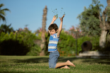 The grassy backdrop sets the scene for the boy's lively antics. Moments like these capture the...