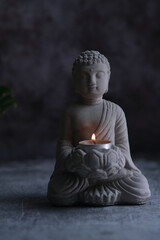 a small stone statue of Buddha