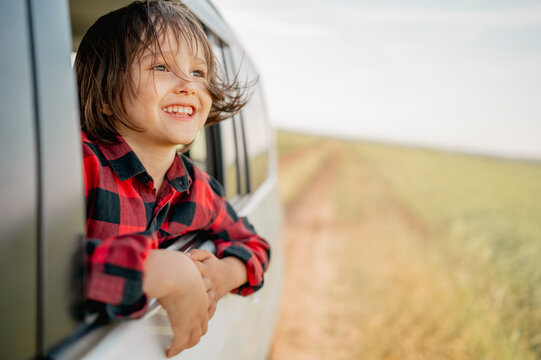Smiling boy looking out of car window