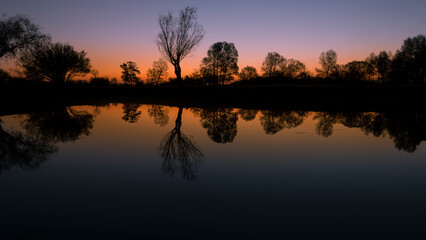 Obraz premium sunset over the river