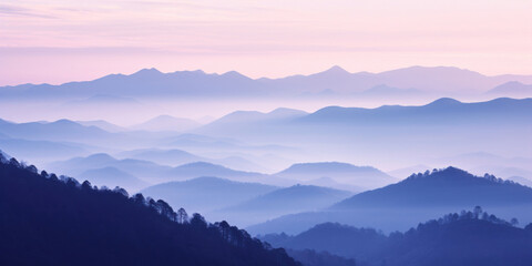 Fototapeta premium The mountains are shrouded in mist, and the last traces of daylight lend a tranquil, mystical quality to the scene. A twilight shot of autumn mountains under a fading pink and purple sky.