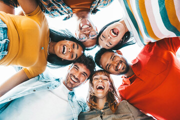 Multicultural community of young people smiling at camera outside - International university...