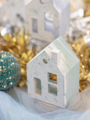 House shaped candle holder. Christmas cozy interior decor. Decorative Christmas-themed figurines. Selective focus