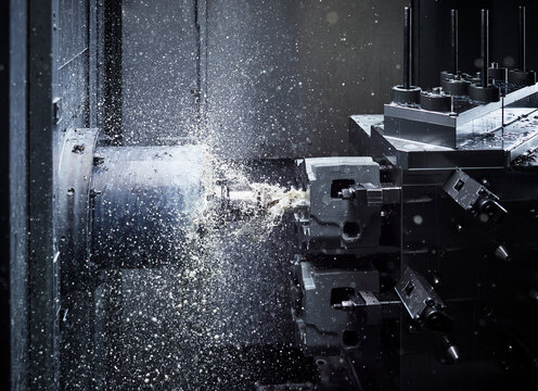 Automatic CNC machine cutting metal in factory