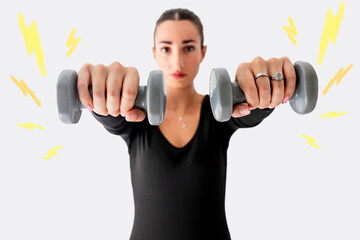 Woman exercising with dumbbell in front of white wall