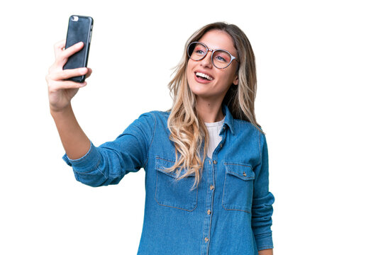 Young Uruguayan woman over isolated background making a selfie